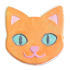 Kitty bath bomb painted with orange tabby kitty colors, orange and gold highlights, with green eyes