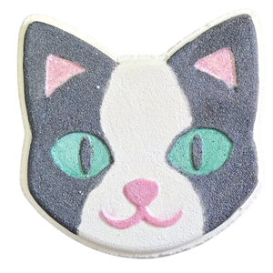 Kitty bath bomb painted with black and white tuxedo kitty colors, black and white, with green eyes