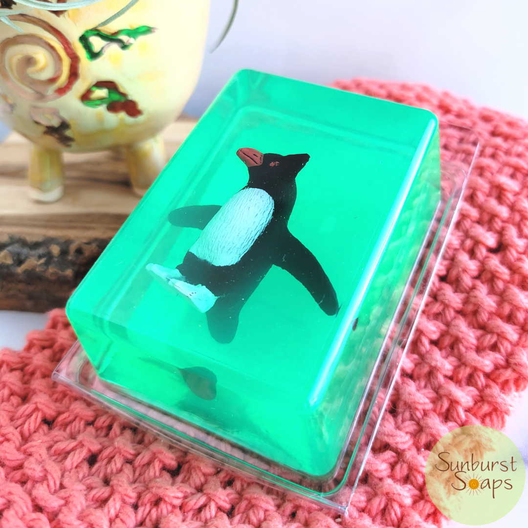 A Penguin Critter Soap in green colored soap scented in melon.